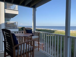 See over the dunes, ocean view with this high-top balcony furniture. 