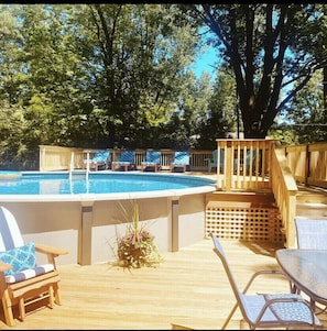 Large 24’ round heated pool with enclosed deck. 4 chaise lounges