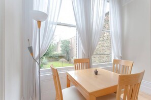 Dinning table with view to the back garden (unfortunately you will not have access to the garden as it belongs to the neighbor downstairs)