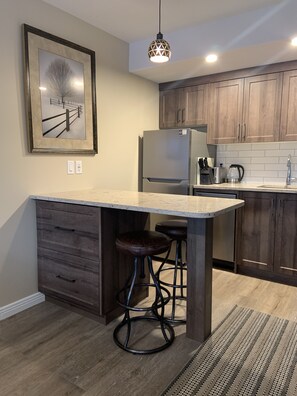 Kitchen with table and 2 stools