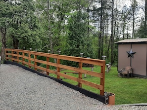 Lighted fence along the driveway.