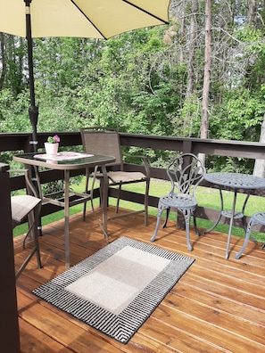 Side deck off sun room with seating area.