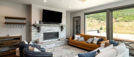 Beautiful modern living room with large windows looking out to open space!