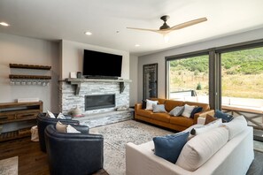 Beautiful modern living room with large windows looking out to open space!