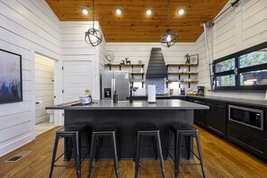 The modern kitchen, with abundant counter space, makes cooking effortless.