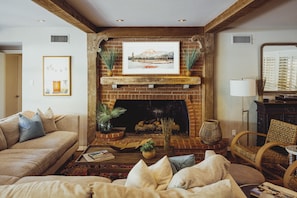 Living room with large sectional and fireplace and TV