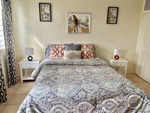 Cozy, tastefully decorated master bedroom with queen-sized bed,  A/C, TV & WiFi