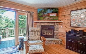 The gas fireplace is located in the living room along with the doors that lead to the hot tub.