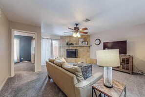 Living room includes a 55" smart television and fill size couch.