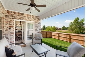 Our backyard oasis is complete with seating, a grill, hot tub, string lights, and a full fence.