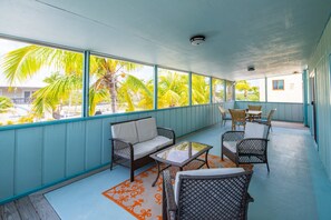 Relish a shaded back porch, perfect for enjoying a meal and watching the boats pass by.