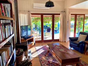 The Lounge with TV, bookcase -- opening to verandah via french doors