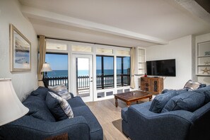 The ocean view living room is comfortably furnished with a  sofa and loveseat.