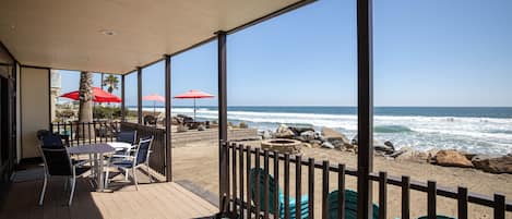 Enjoy alfresco dining and watching the waves flow in from your private deck, leading to a sandy yard.
