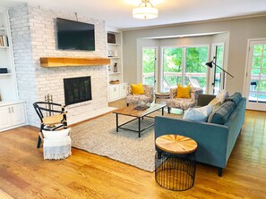 Large upstairs living room with fireplace and beautiful views of the lake. 