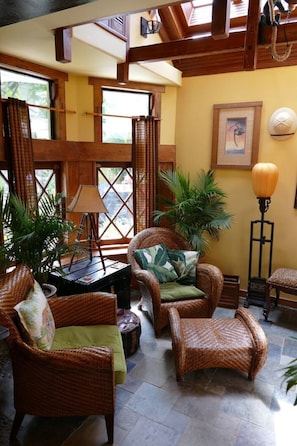 Living room space with rattan chairs.
