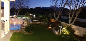 Apartment Palmyra 2 - View in the Evening of the Garden and Swimming Pool Site