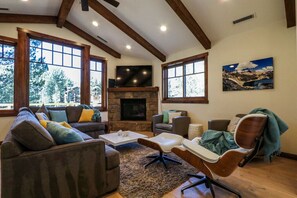 Living room with golf course views, gas fireplace and 65 inch TV