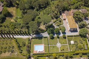 The aerial view of the property with the park and swimming pool