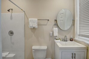 Bathroom - Stylish bathroom boasting contemporary sink and counter with a nice size bath