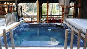 Relaxing hot tub with sliding doors into veranda immediately behind