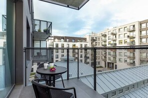 Spacious balcony with outdoor furniture.