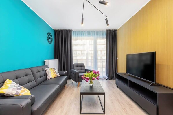 Living room with a comfortable sofa and TV. 