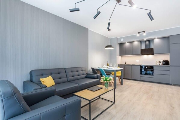 Living room with large windows flooding the room with natural light, highlighting its bright decor.