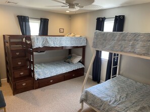 Cozy kids' room with two sets of bunk beds and smart TV.