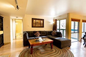 The living area features a wood burning fireplace and a flat screen TV.