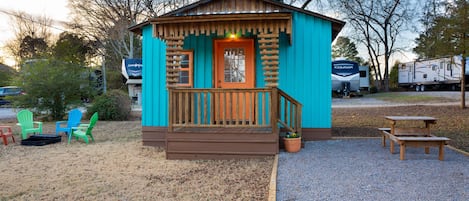 Fire pit area with Adirondack chairs and picnic table