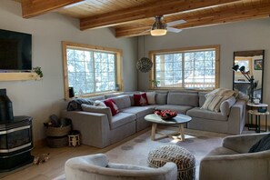 Living room with gas fireplace and cozy couch.
