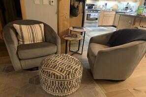Cozy chairs in front of the fireplace in the living room.