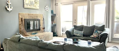 Living area with fireplace and fan