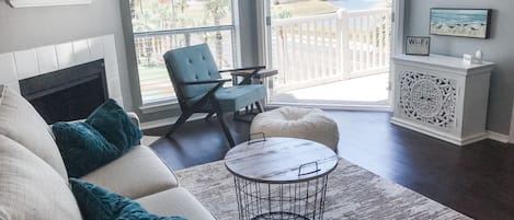 open living room layout with French Doors that look straight out to a water view