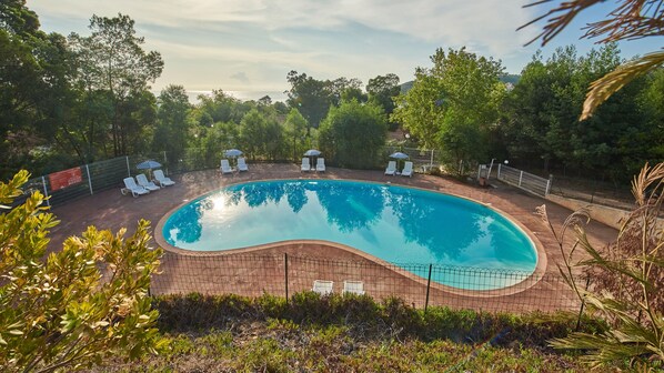 Bask in the Corsican sun at our residence's central amenity - the pristine outdoor pool, surrounded by native flora.