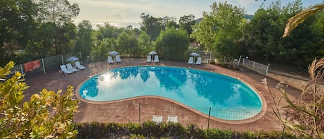 Bask in the Corsican sun at our residence's central amenity - the pristine outdoor pool, surrounded by native flora.