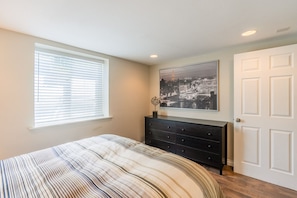 Quiet back bedroom has a queen bed and large dresser and closet.