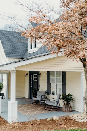 Closer view of front of cottage showing the large front porch.