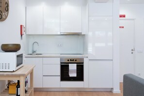 The kitchen is equipped with oven, stove, microwave, washing machine, ceramic hob and exhaust fume.
