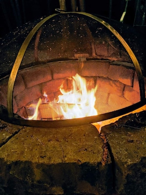 Warm up by our outdoor firepit. Comfy, cushioned chairs included.