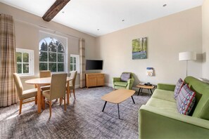 Bright dining and living area with comfortable seating.