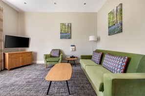 Modern living space with a touch of color and ample natural light.