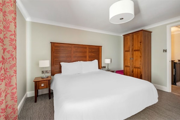 A restful bedroom retreat with a welcoming bed and homey details.