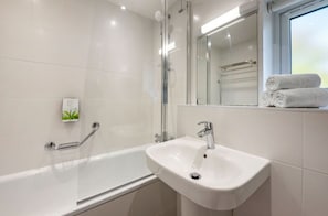 A modern and clean bathroom equipped with a full bathtub and a bright, welcoming design.
