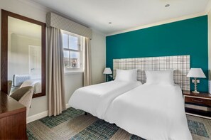 Bedroom featuring a striking accent wall and comfortable furnishings for a restful stay.