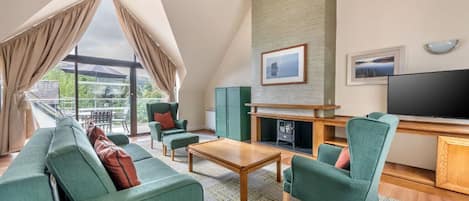 Inviting living area with vaulted ceilings and a cozy seating arrangement.