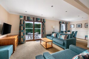 A welcoming open-plan living space with plush seating and a homely feel.