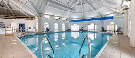 Another view of the indoor pool, showcasing the expansive space and multiple lanes.