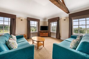 Another angle of the living area showing its spacious layout and comfortable furnishings.
